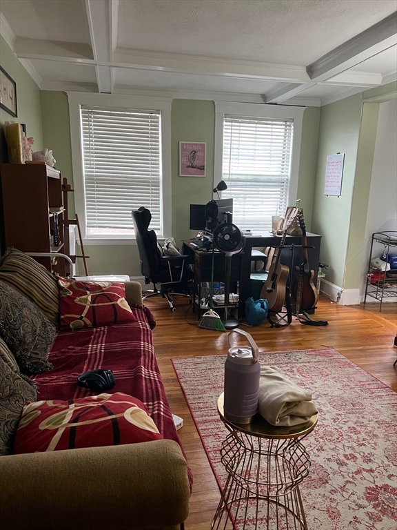 110 Lanark Road, Unit 5 Boston, MA 02135 - Photo 11 of 17 a living room with furniture a window and gym equipment