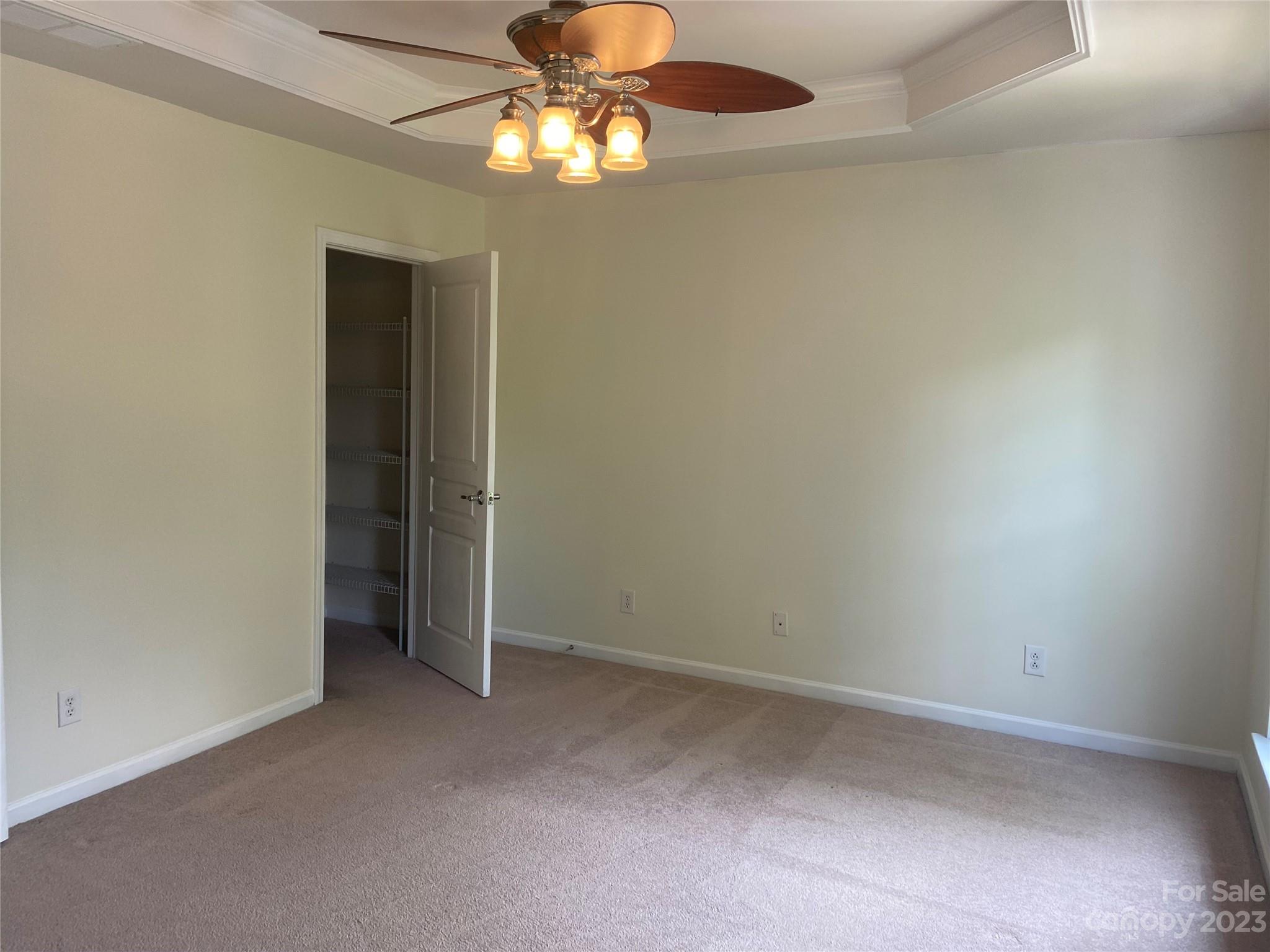 724 Passage Drive Fort Mill, SC 29708 - Photo 12 of 20 an empty room with a chandelier fan and closet