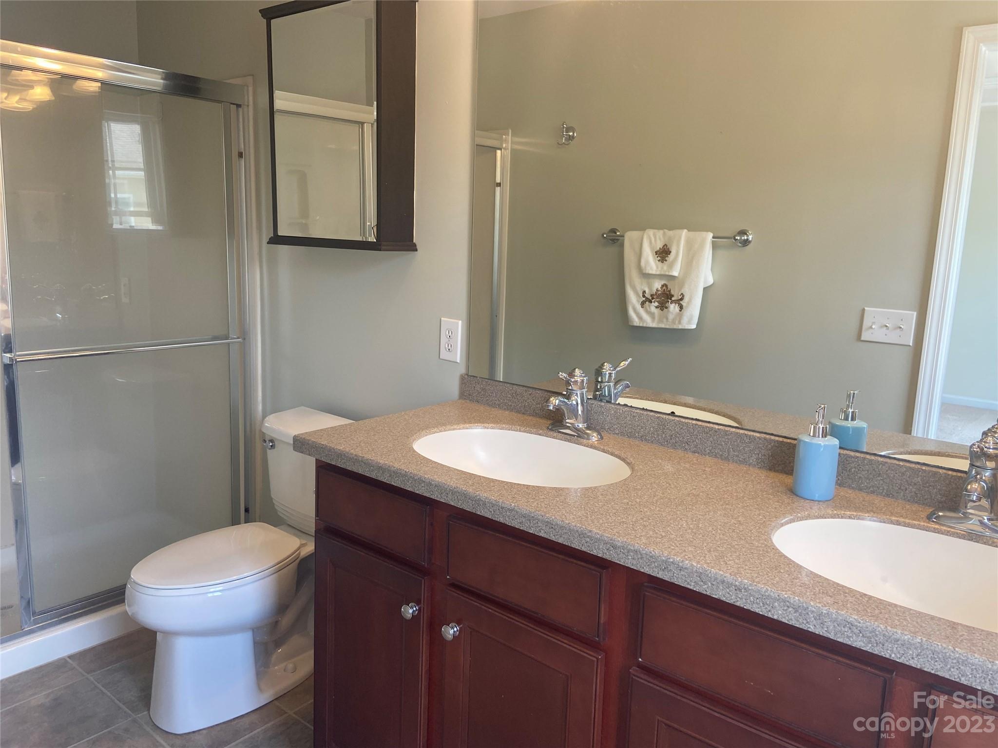 724 Passage Drive Fort Mill, SC 29708 - Photo 16 of 20 a bathroom with a granite countertop sink toilet and mirror