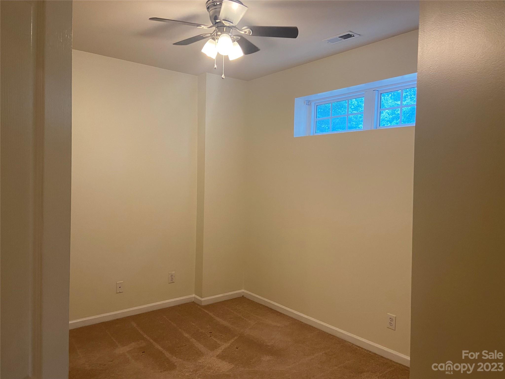 724 Passage Drive Fort Mill, SC 29708 - Photo 18 of 20 an empty room with a window and a fan