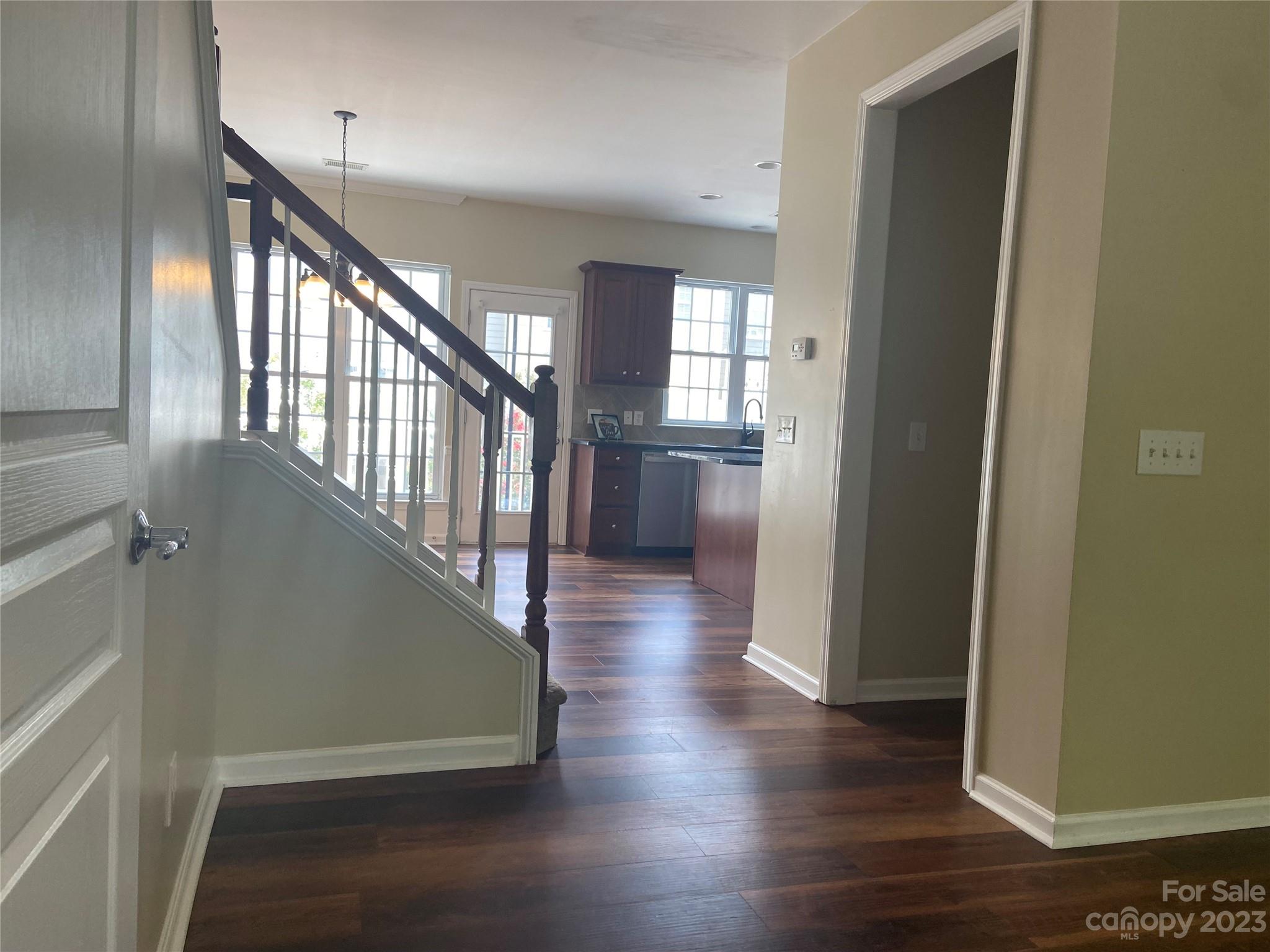 724 Passage Drive Fort Mill, SC 29708 - Photo 4 of 20 a view of a hallway with wooden floor and stairs