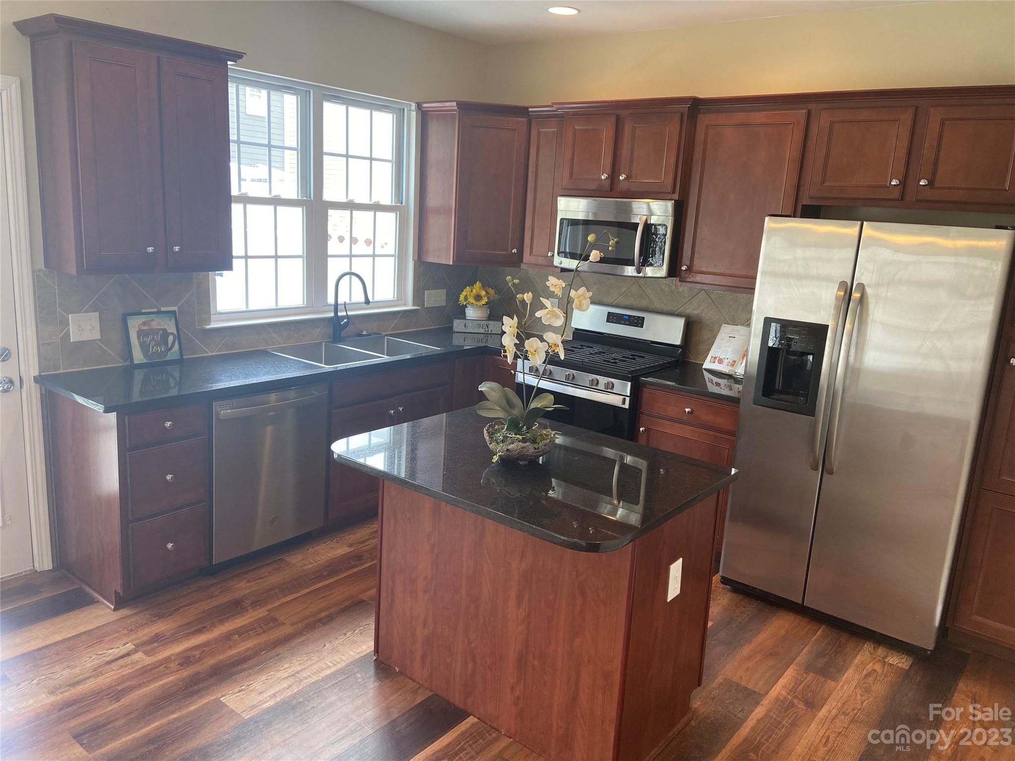 724 Passage Drive Fort Mill, SC 29708 - Photo 6 of 20 a kitchen with kitchen island granite countertop a sink stove and refrigerator