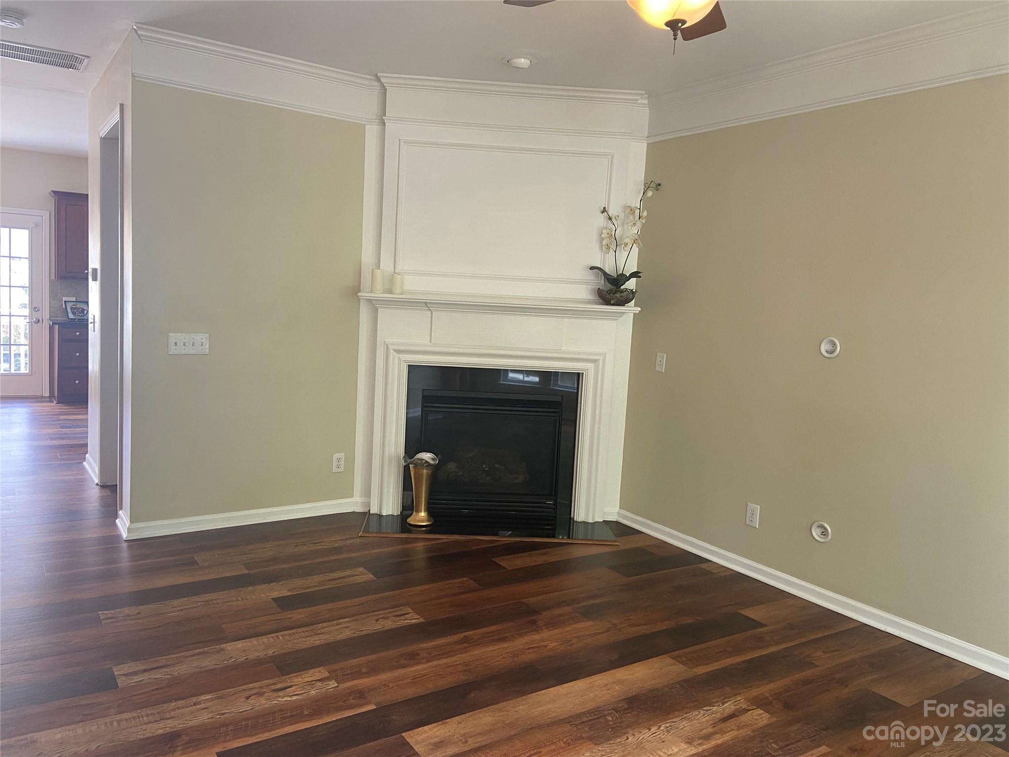 724 Passage Drive Fort Mill, SC 29708 - Photo 8 of 20 a view of an empty room with wooden floor and a fireplace