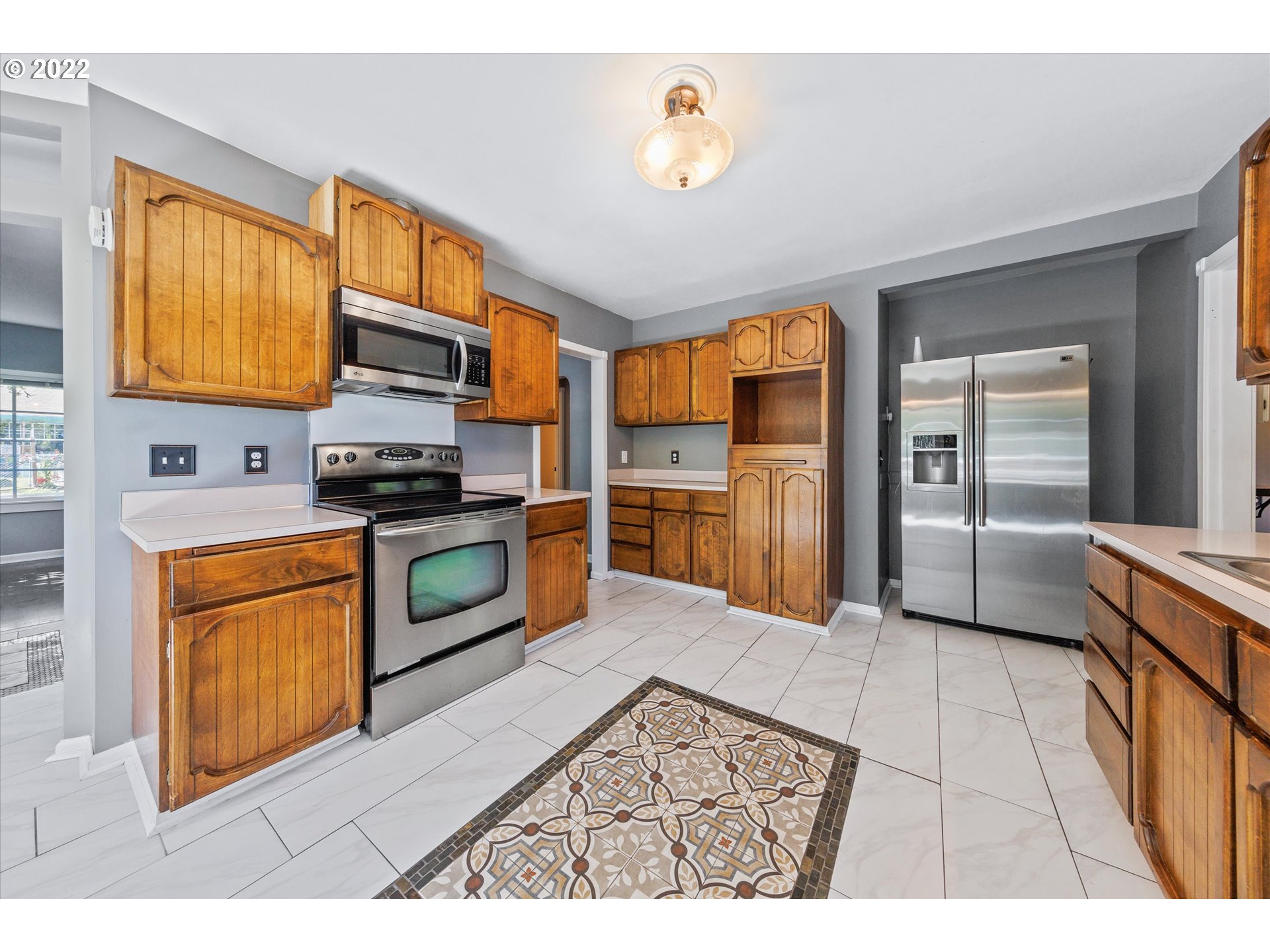 3200 R Street Vancouver, WA 98663 - Photo 7 of 32 a kitchen with stainless steel appliances granite countertop a refrigerator stove top oven a sink and dishwasher
