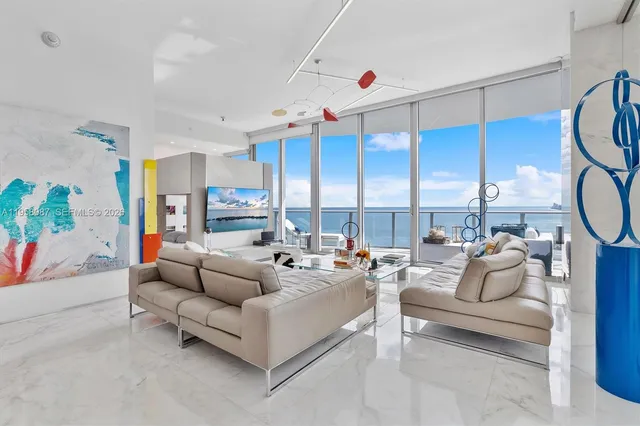 a living room with furniture a rug and white walls