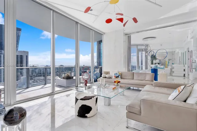 a living room with furniture and a floor to ceiling window