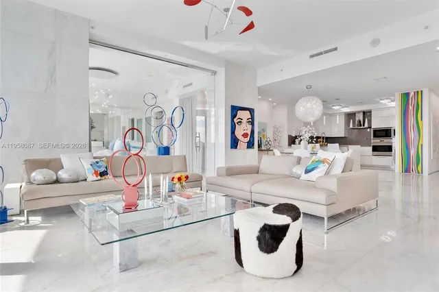 a living room with furniture and kitchen view