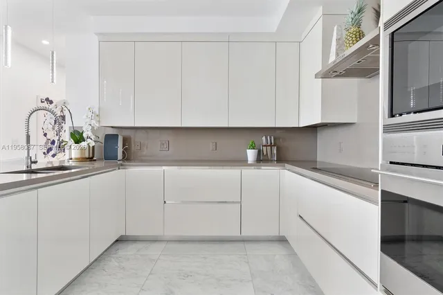a kitchen with cabinets appliances and a sink