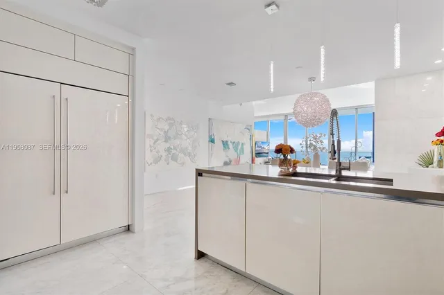 a kitchen with kitchen island a sink stainless steel appliances and cabinets