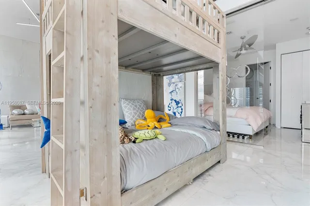 a bedroom with a bed couch and a window