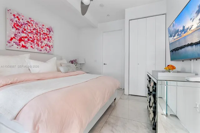 a bedroom with a bed and a painting on the wall