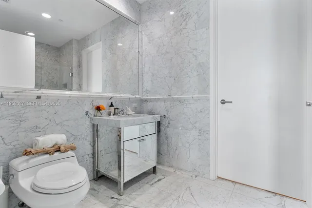 a view of bathroom with a sink toilet and a mirror