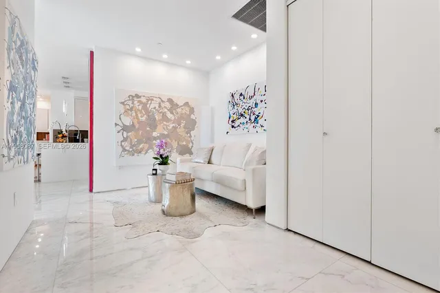 a living room with furniture and floor to ceiling window