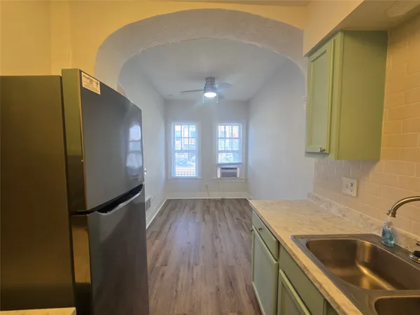 a kitchen with a sink a refrigerator freezer and a dishwasher