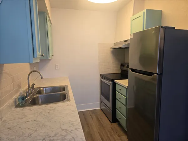 a kitchen with a refrigerator and a sink
