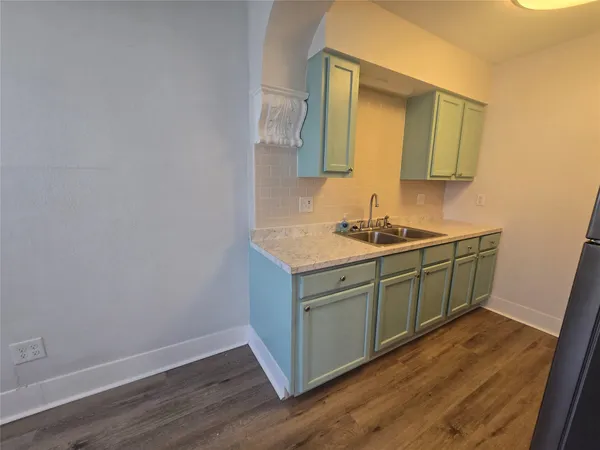 a kitchen with sink and mirror
