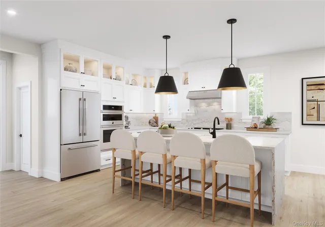 a view of kitchen with furniture and stainless steel appliances