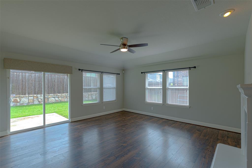 616 England Street Fate, TX 75189 - Photo 14 of 40 Living room with a healthy amount of sunlight, dark hardwood / wood-style floors, and ceiling fan