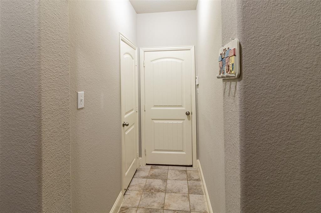 616 England Street Fate, TX 75189 - Photo 15 of 40 Corridor with light tile flooring to garage