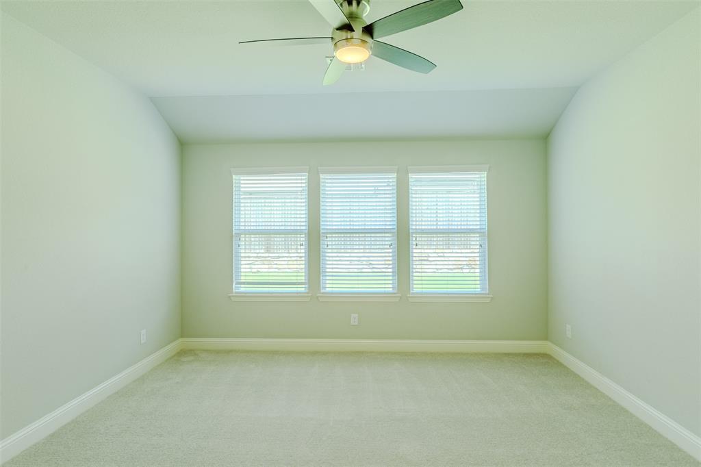 616 England Street Fate, TX 75189 - Photo 18 of 40 Unfurnished room featuring healthy amount of natural light, new carpet flooring, ceiling fan, and lofted ceiling