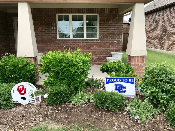 a view of sign board with flower plants