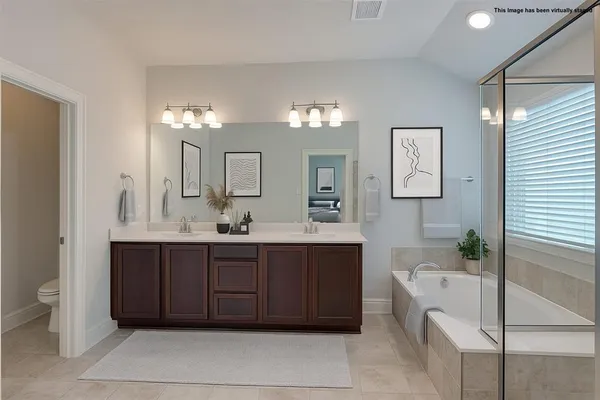 a spacious bathroom with a tub shower and sink