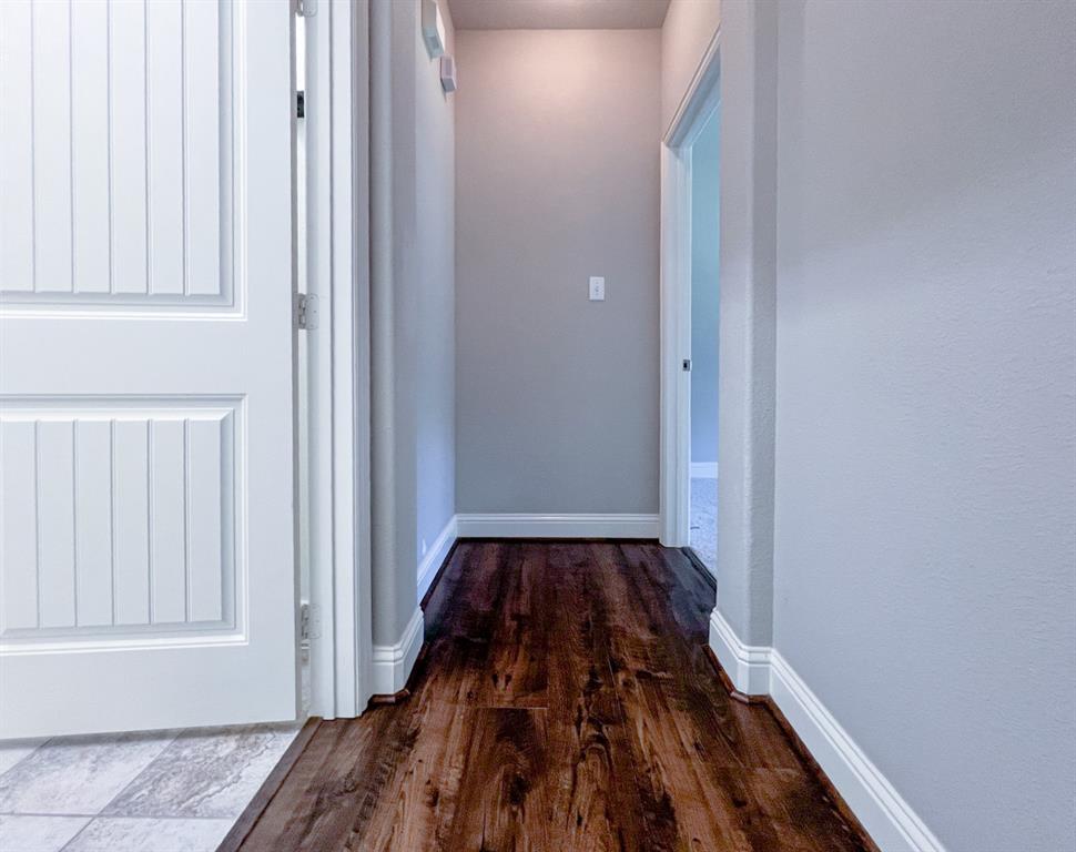 616 England Street Fate, TX 75189 - Photo 27 of 40 Hallway to Master bedroom featuring baseboards and wood finished floors