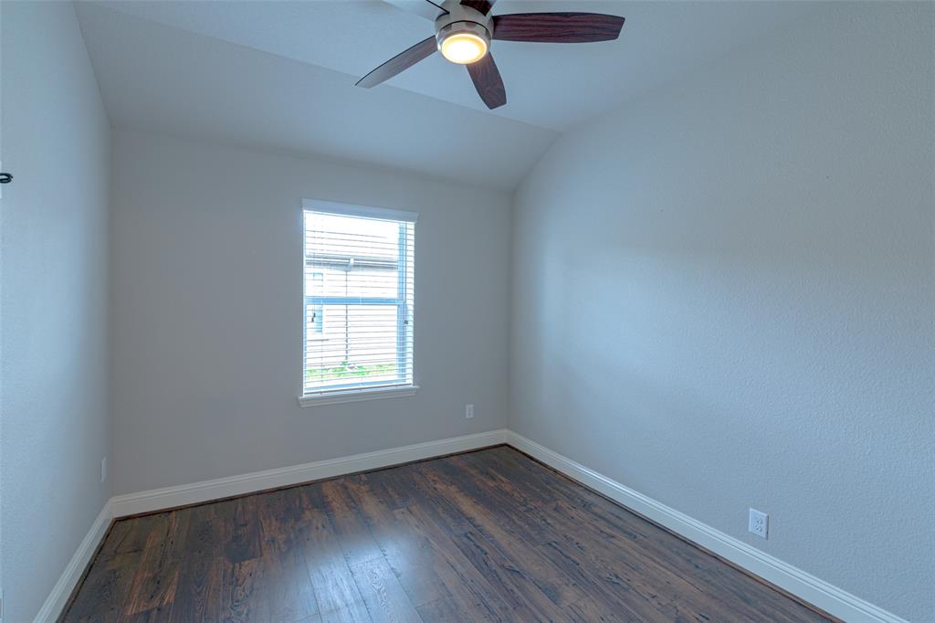 616 England Street Fate, TX 75189 - Photo 31 of 40 Spare room featuring ceiling fan, dark hardwood / wood-style flooring, and vaulted ceiling