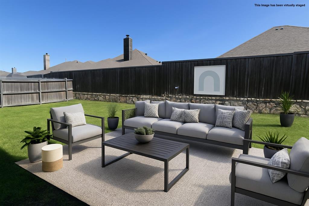 616 England Street Fate, TX 75189 - Photo 32 of 40 Visual staged fenced backyard with outdoor seating and a patio