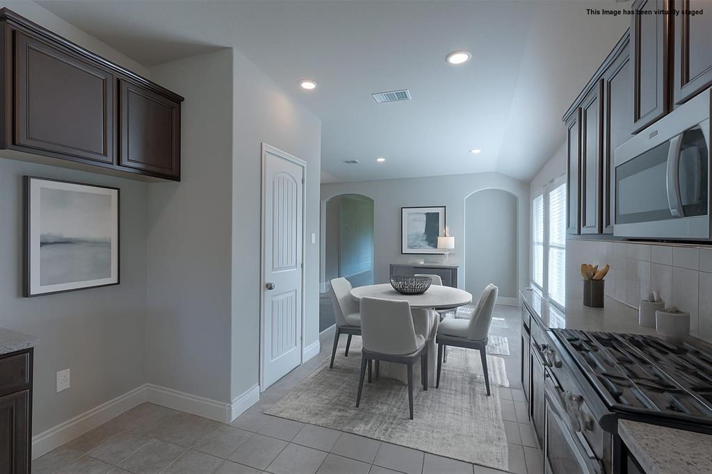 616 England Street Fate, TX 75189 - Photo 7 of 40 Visual staged Dining room with recessed lighting, lofted ceiling, light tile patterned floors, and arched walkways