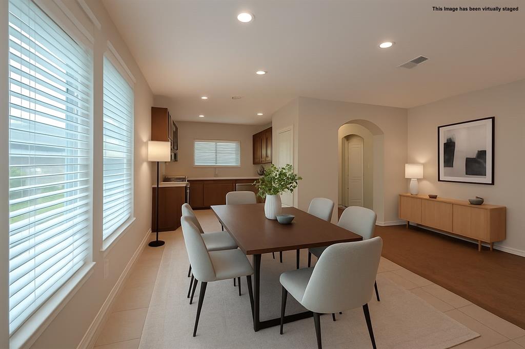 616 England Street Fate, TX 75189 - Photo 9 of 40 Visual staged Dining area with arched walkways and recessed lighting