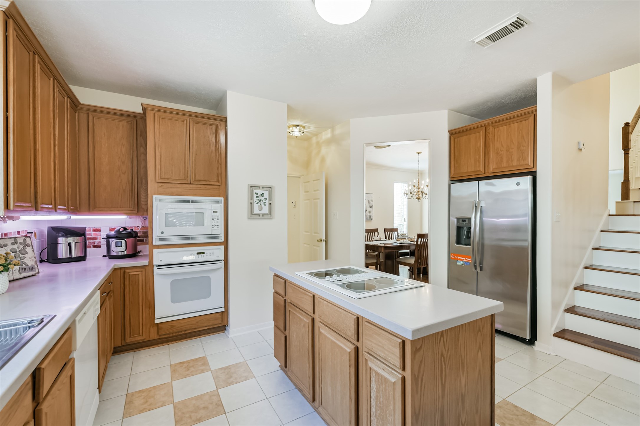 9206 Memorial Hills Drive Spring, TX 77379 - Photo 18 of 50 a kitchen with a refrigerator sink and stove