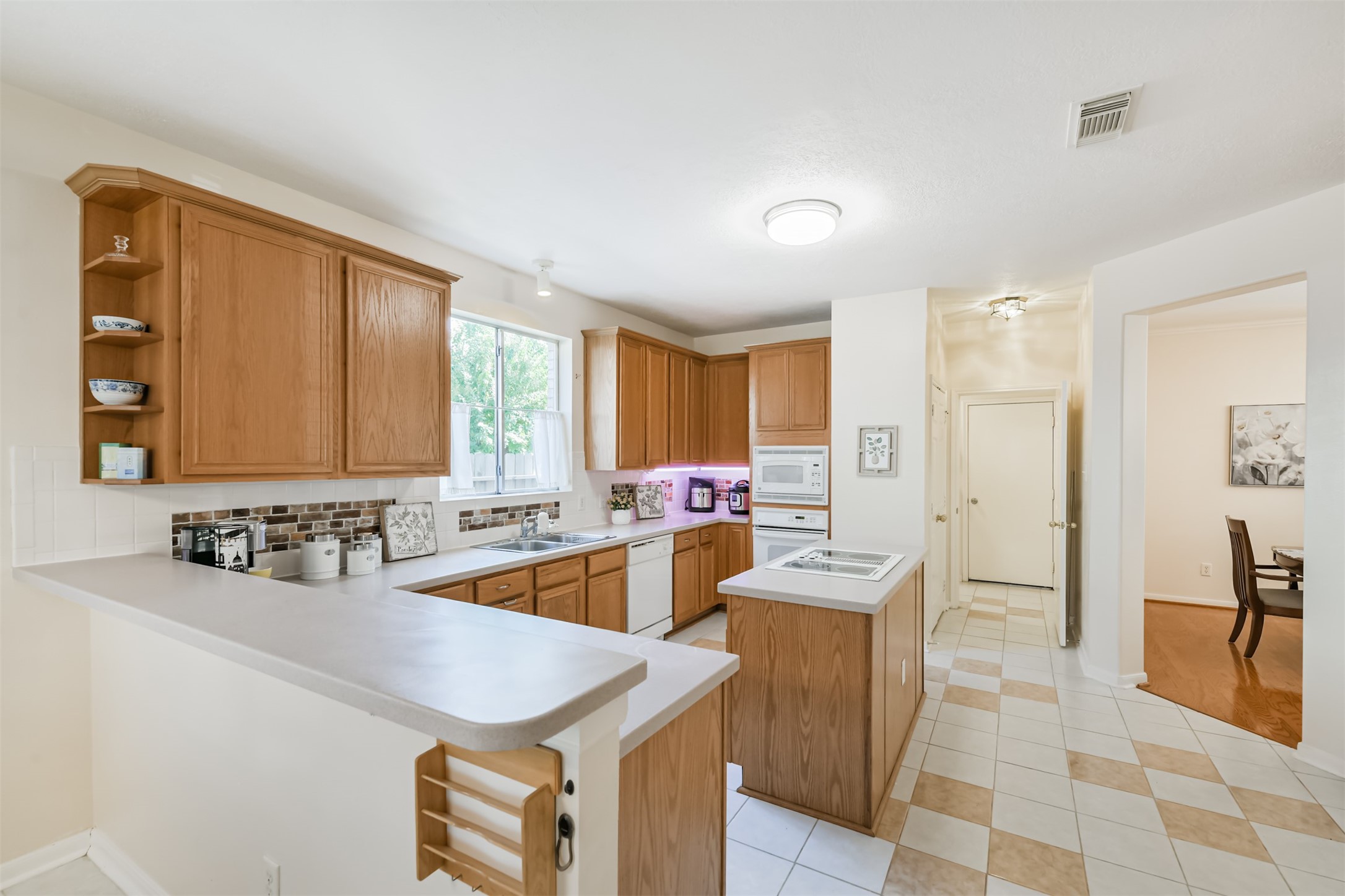 9206 Memorial Hills Drive Spring, TX 77379 - Photo 21 of 50 a kitchen with a sink a counter top space and stainless steel appliances