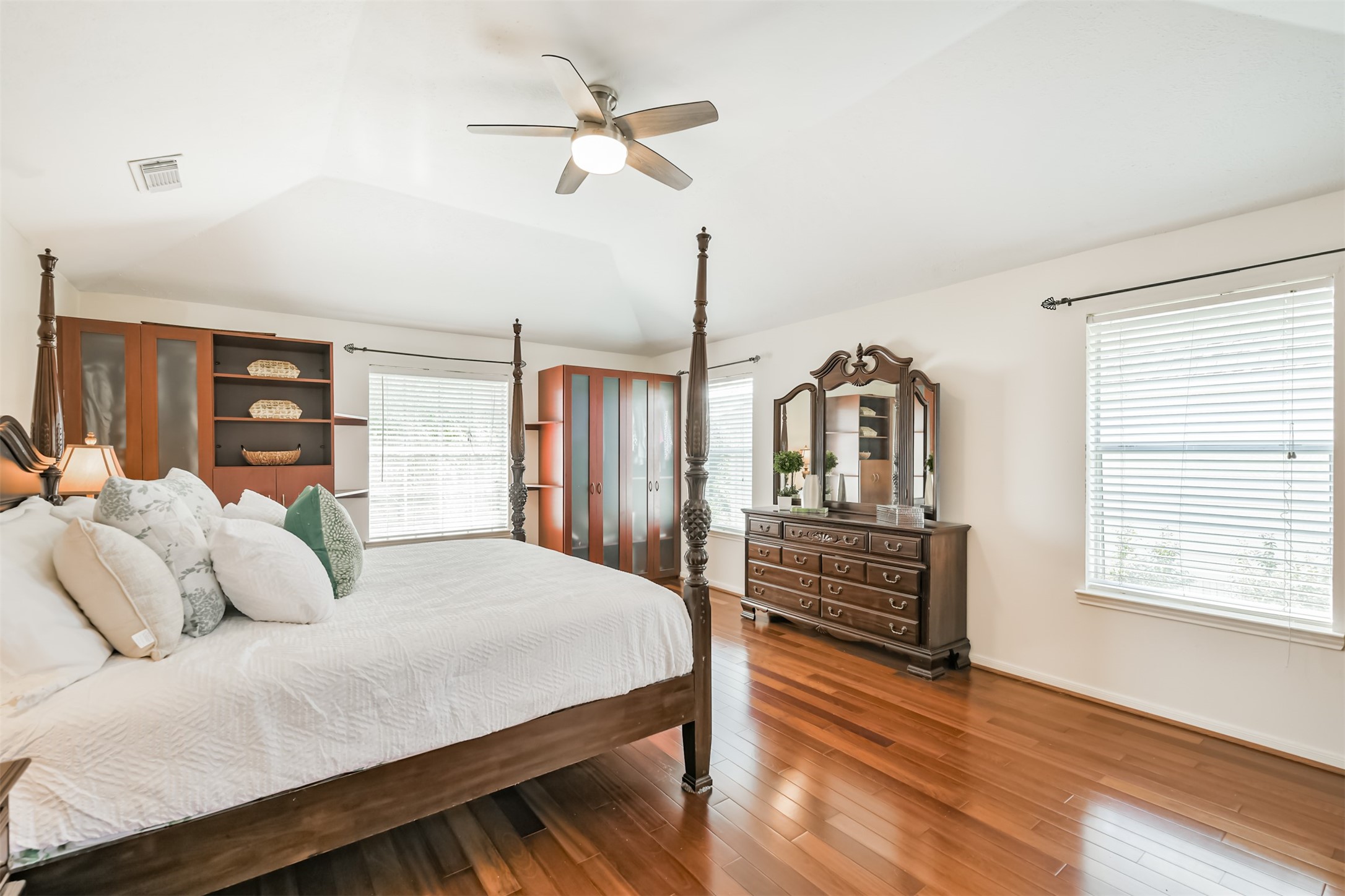 9206 Memorial Hills Drive Spring, TX 77379 - Photo 26 of 50 a bedroom with a large bed and wooden floor