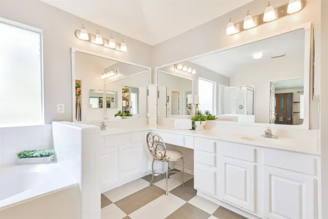 a view of a bathroom with a walk in closet with wooden floor