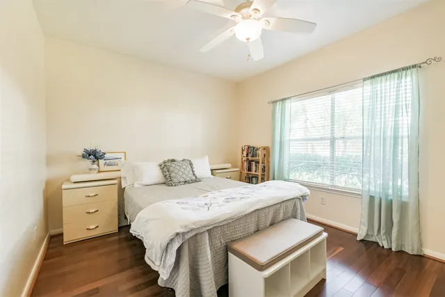 a bedroom with a large bed a chandelier and closet