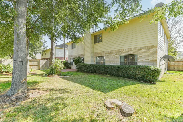 a view of a house with a backyard