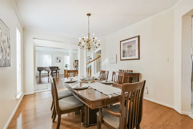 a view of a dining room with furniture and chandelier