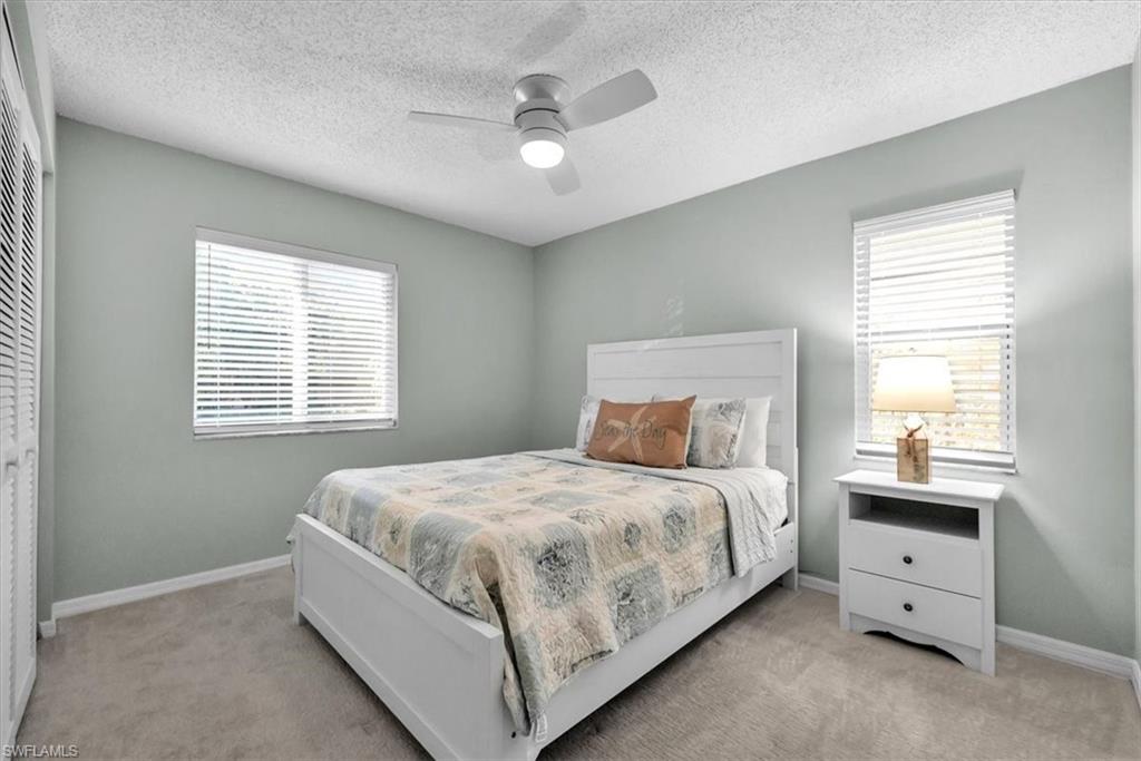 280 Timber Lake Circle, Unit H201 Naples, FL 34104 - Photo 15 of 33 a bedroom with a bed and a window