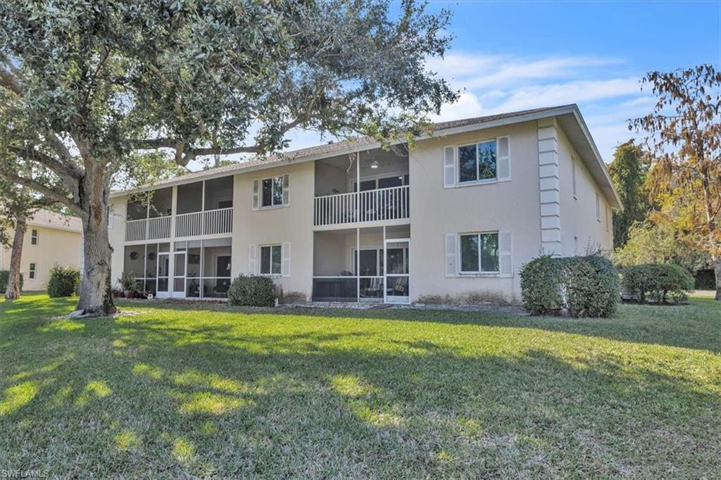 280 Timber Lake Circle, Unit H201 Naples, FL 34104 - Photo 23 of 33 a view of a house with a yard and large tree