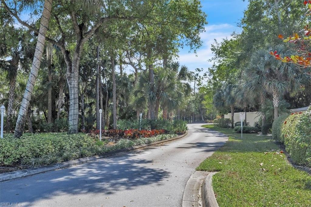 280 Timber Lake Circle, Unit H201 Naples, FL 34104 - Photo 28 of 33 a view of a street with large trees