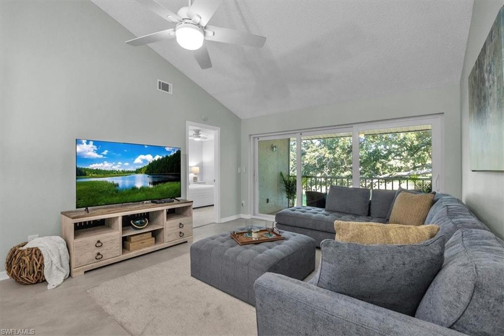 280 Timber Lake Circle, Unit H201 Naples, FL 34104 - Photo 7 of 33 a living room with furniture and a flat screen tv
