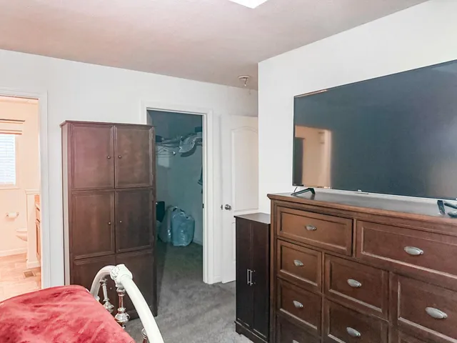 a bedroom with a bed and a mirror