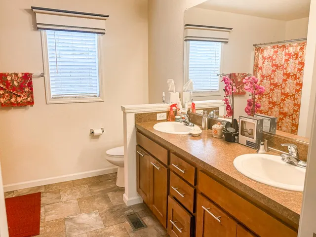 a bathroom with a sink a toilet and a mirror