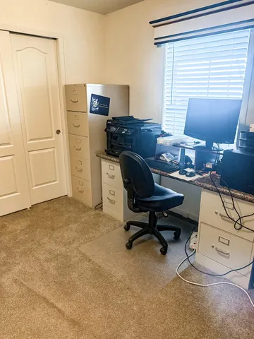 a workspace with furniture and a window