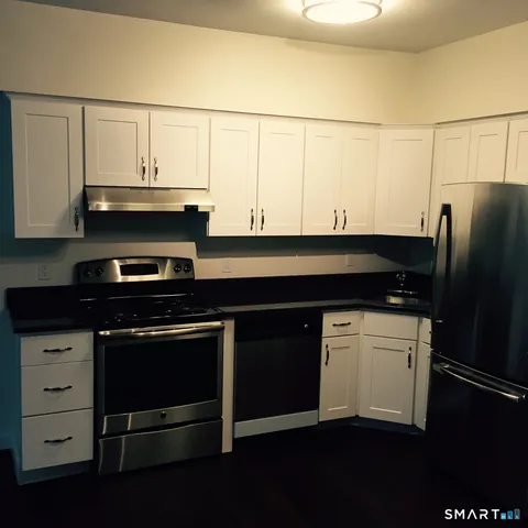 a kitchen with stainless steel appliances a stove and a refrigerator