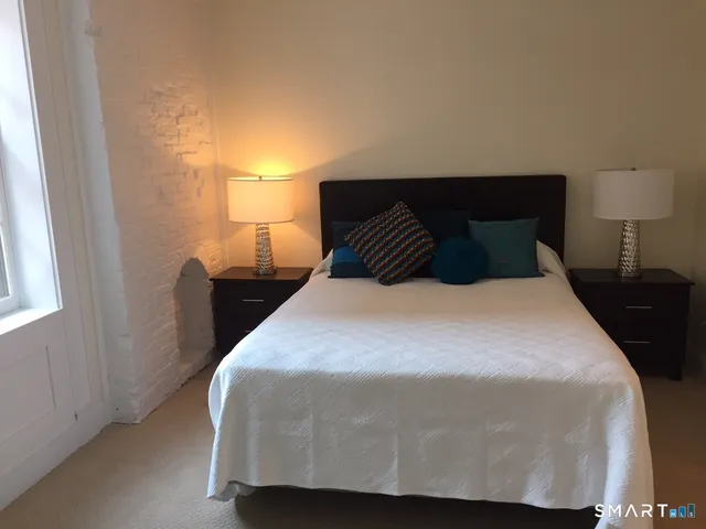 a bedroom with a bed and window