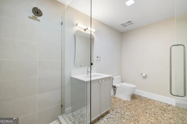 a bathroom with a toilet a sink and shower
