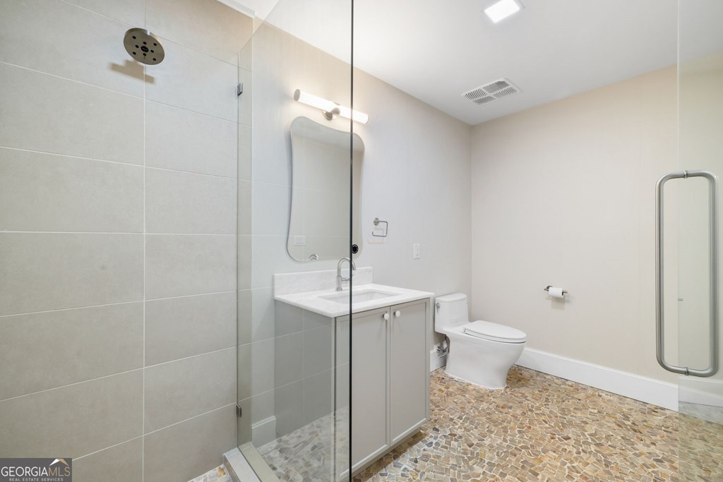 1281 East Main Street Blue Ridge, GA 30513 - Photo 12 of 19 a bathroom with a toilet a sink and shower