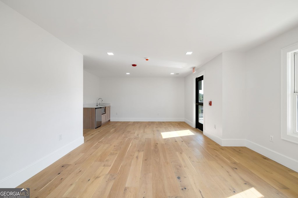 1281 East Main Street Blue Ridge, GA 30513 - Photo 5 of 19 wooden floor in an empty room with a window